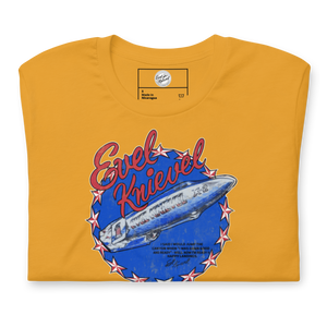Evel Knievel® Snake River Canyon 1974 tee in mustard, full front of the shirt with the distressed rocket badge
